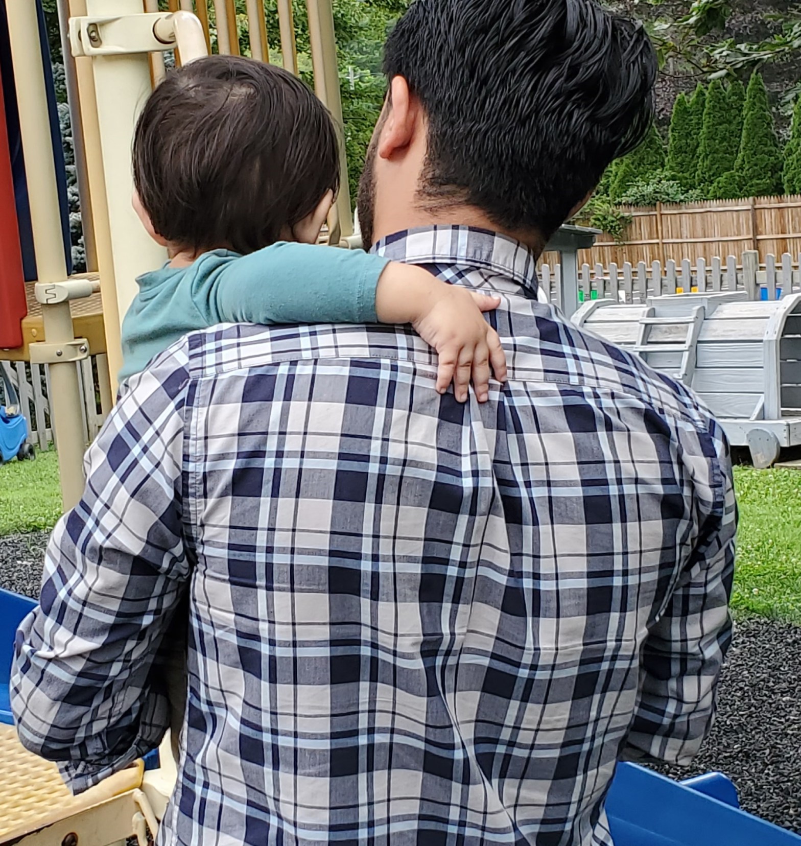 As Abdullah talked about the road to his new life in Westchester, his 1-year-old son fidgeted in his arms. Photo by Robert Brum